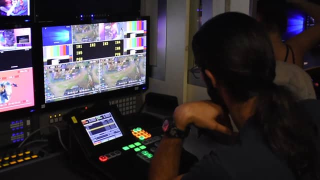 A vision mixer and monitor wall in a live broadcast control room