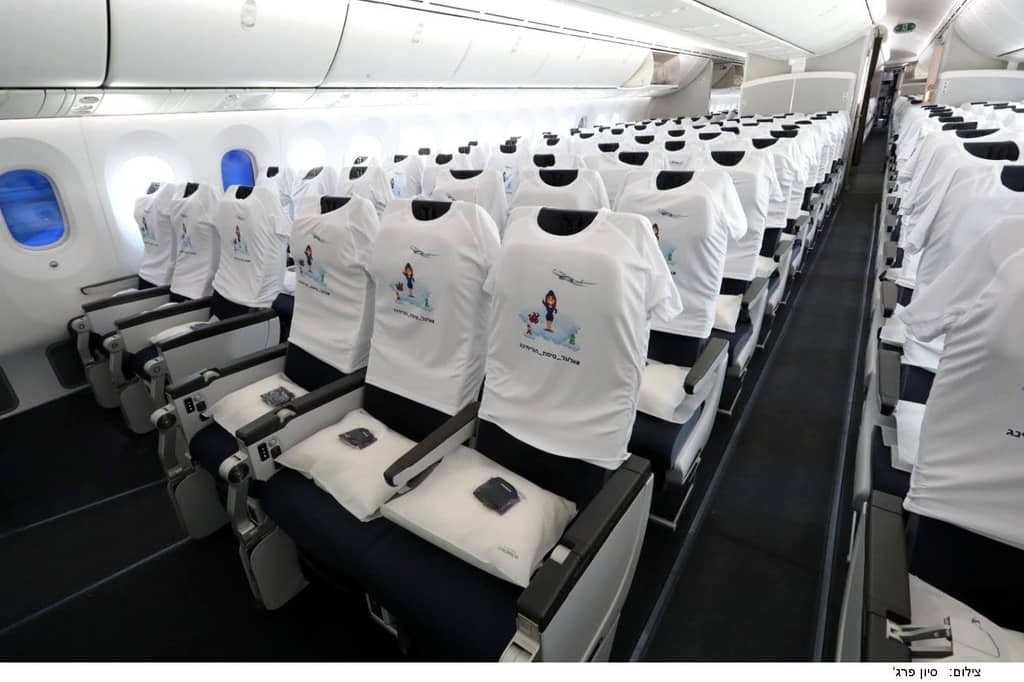 Rows of seats aboard a Boeing 787, each dressed in a printed T-shirt